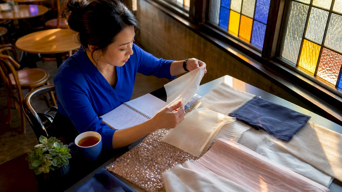 Event planner evaluating fabric backdrop samples at desk